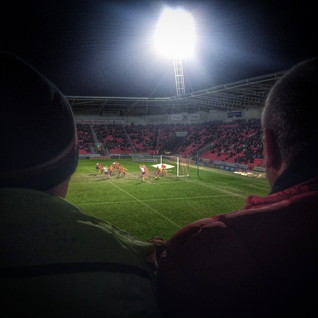 Supporters watch on as Doncaster Rovers host Bradford City at the Keepmoat Stadium