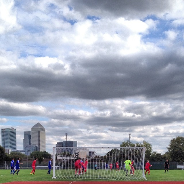 FC Clacton defend a Sporting Bengal United corner in front of a backdrop of Canary Wharf in their FA Cup extra preliminary round match
