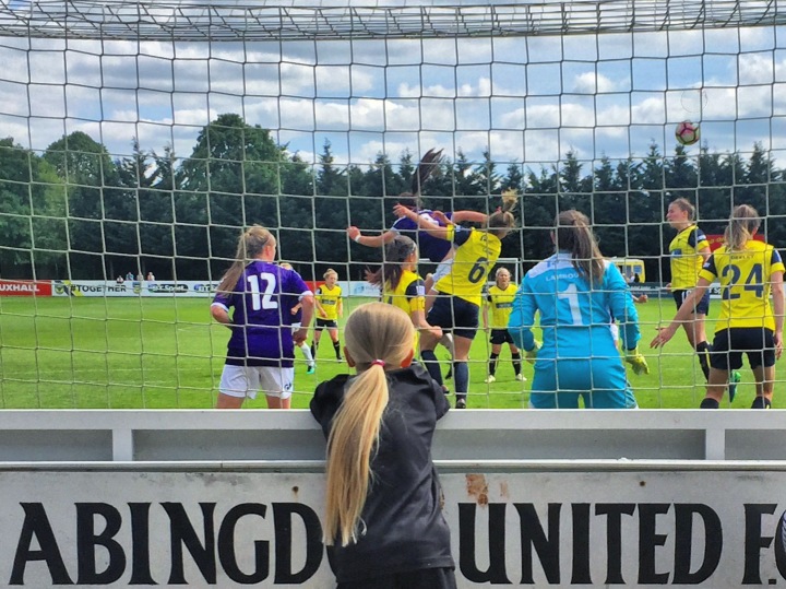 A young female fan watches a Doncaster Rovers Belles corner during their 4-0 win at Oxford United in FA Women's Super League 2