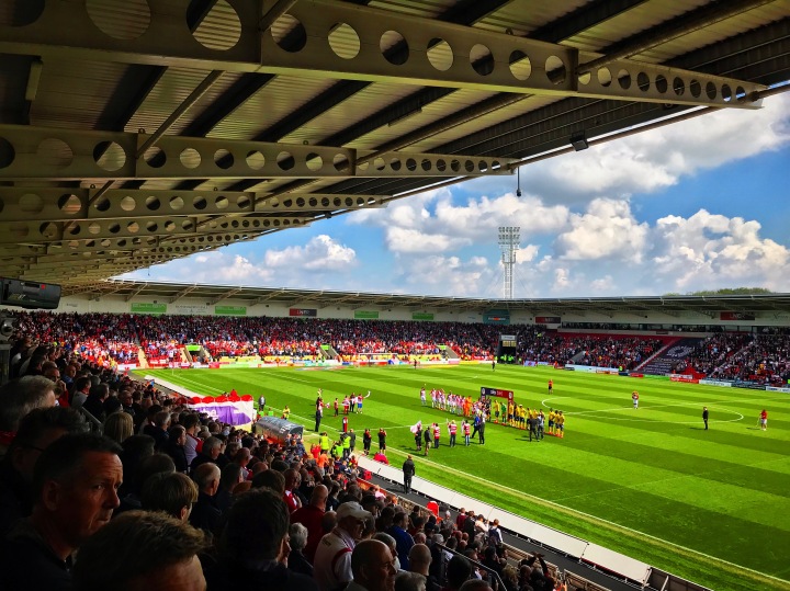The players enter the Keepmoat Stadium pitch ahead of the League One Play-Off Semi-Final first leg