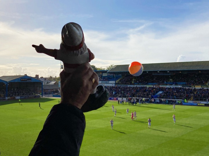 A gnome is held aloft and a beach ball flies through the air as the Doncaster Rovers players enter the field at Carlisle united's Brunton Park