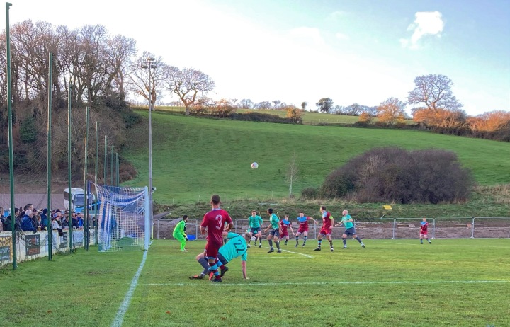A Colwyn Bay player (number 3) crosses the ball during his team's home match against Guilsfield